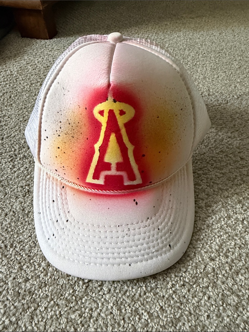 White Mesh Trucker Cap with Yellow & Red Spray Logo